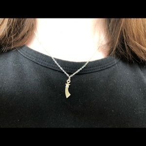 Silver shooting star necklace.